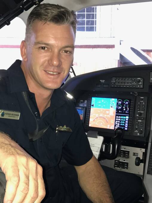 Adam Booker in the cockpit of the NT Police Air Wing aircraft. Picture: supplied