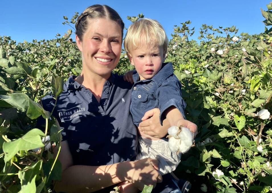 Anyone for cotton? Ellie Parkinson with her two-year-old, William, in the cotton crop at Marathon. Picture: Judith Maizey