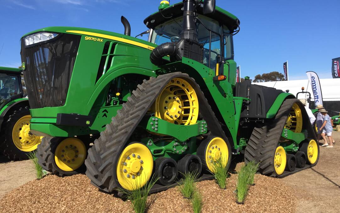 Here's a Deere 9RX demonstrating its tractive ability by climbing a small mound.