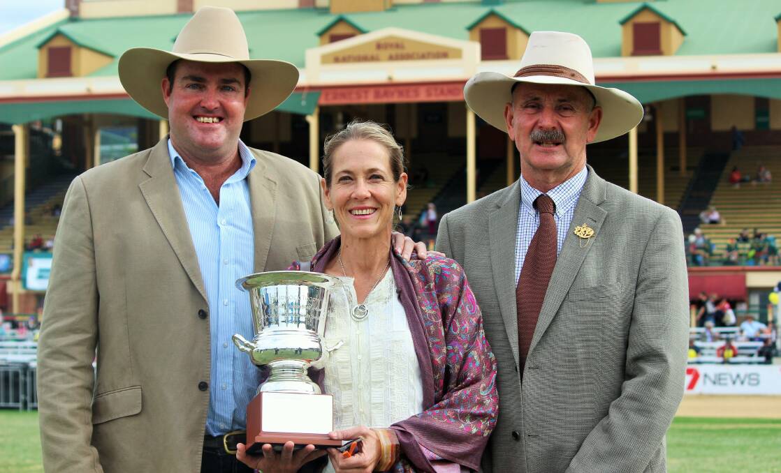 Queensland Shorthorn breeders Spencer and Sophie Morgan, The Grove, with Duncan Sturrock presenting the trophy for Paddock to Palate Champions at the Royal Queensland Show in 2013. 