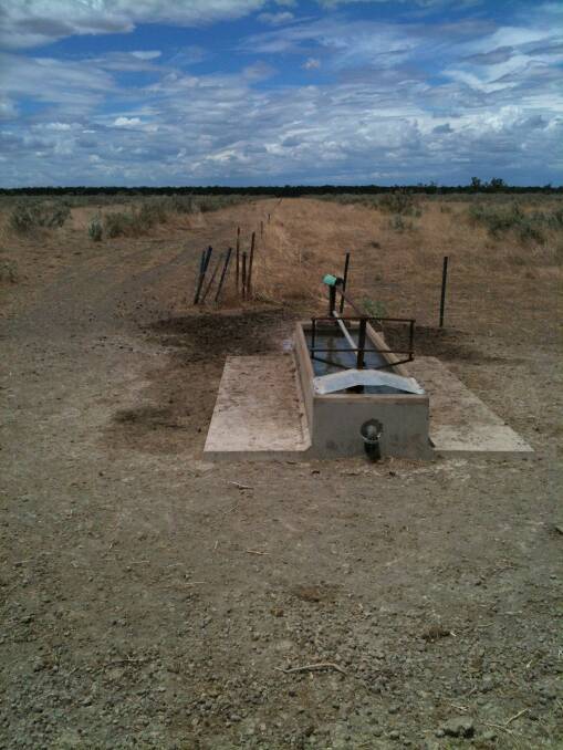 A remote water trough fitted with a commercial-style water meter with communication monitoring technology on a western Queensland property.