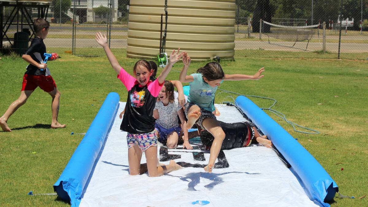 St Patricks Primary School students testing out Booringa's new waterslide.