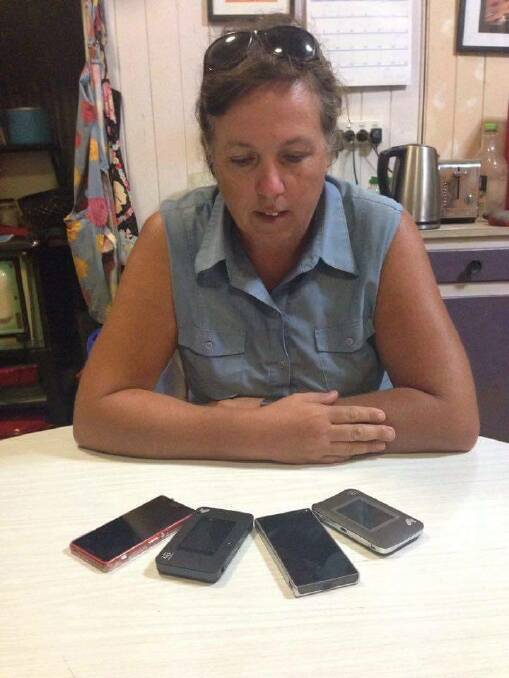 Claire Kapernick, who lives 12km from Murgon, shows the array of devices she had to resort to, to get enough internet data before SkyMuster was installed.