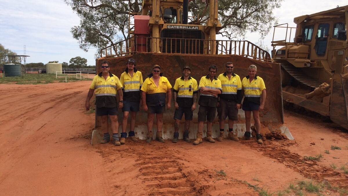 The Telstra team that laid the fibre optic cable in the red dirt of south west Queensland. Photo supplied by Bruce Scott.