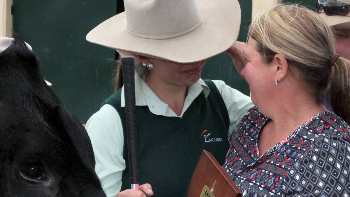 Winners are grinners: There were tears of joy for 19-year-old Tyler Smith as Cowgirl Zola's Shadow was announced grand champion Limousin cow or heifer in judging on Friday morning. Picture: Sally Cripps.