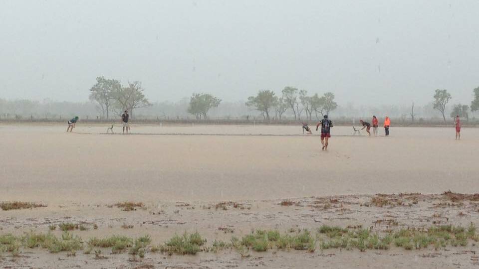 Only in Australia: It was a slow outfield but no-one minded sloshing through a few millimetres of water on the Blackall Country Cricket Club pitch on Sunday. Picture: Cassie Turner.