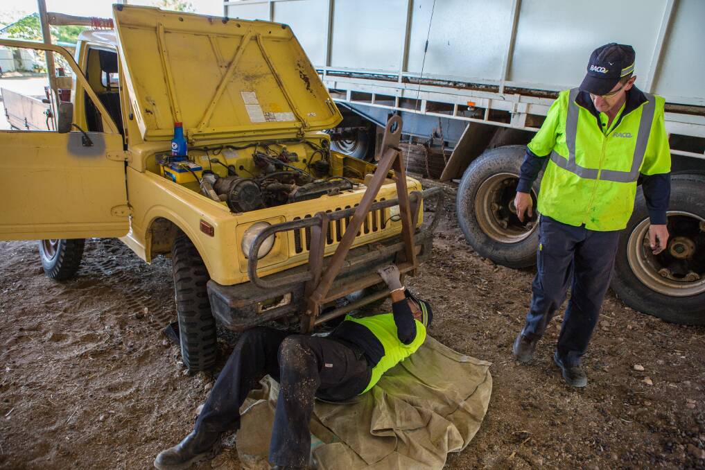 Terry Peters and Simon McClelland working on a car at Don and Jar Milne's Longreach property, Tandara.