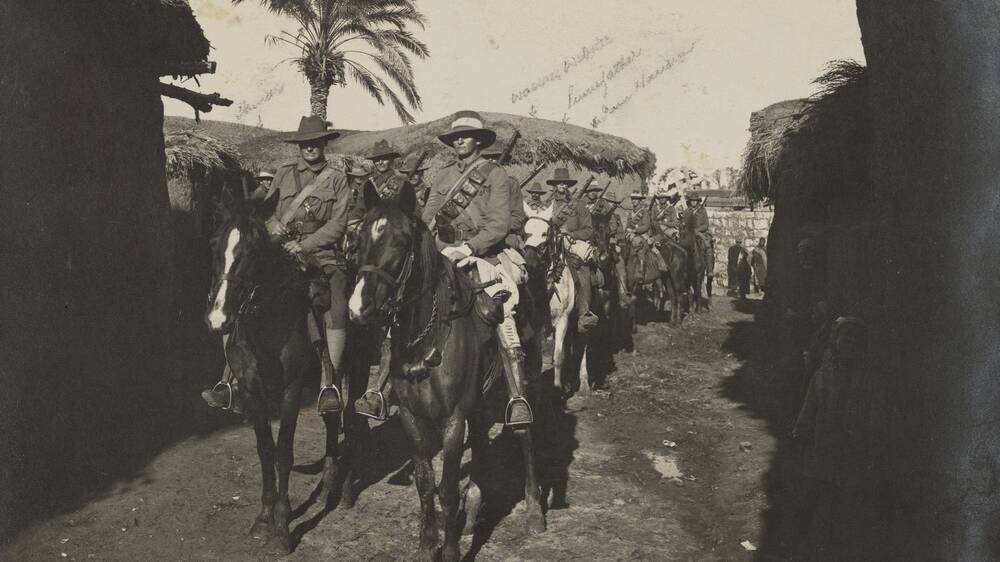 A Light Horse patrol passing through Zernukah, Israel in 1918. Photo sourced from State Library of Queensland.