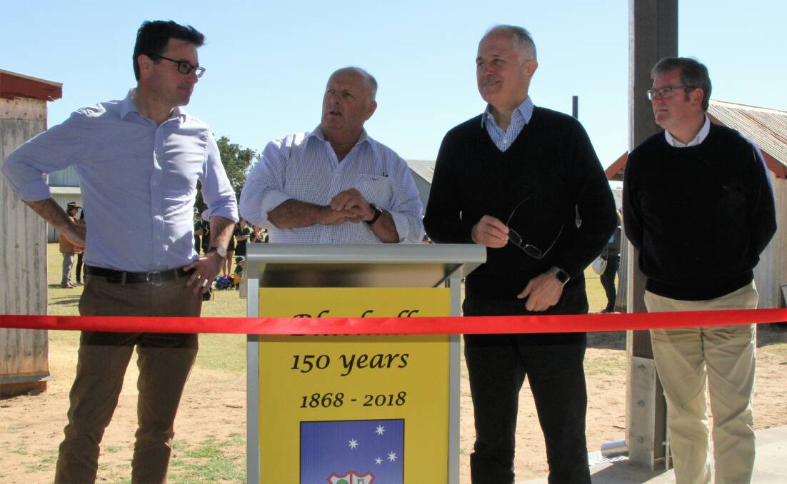 Blackall-Tambo Regional Council mayor, Andrew Martin, second left, introduces Agriculture Minister, David Littleproud, Prime Minister, Malcolm Turnbull, and Regional Development Minister, John McVeigh to the people gathered at the Blackall Woolscour, and inviting the Prime Minister to open extensions to the heritage complex.