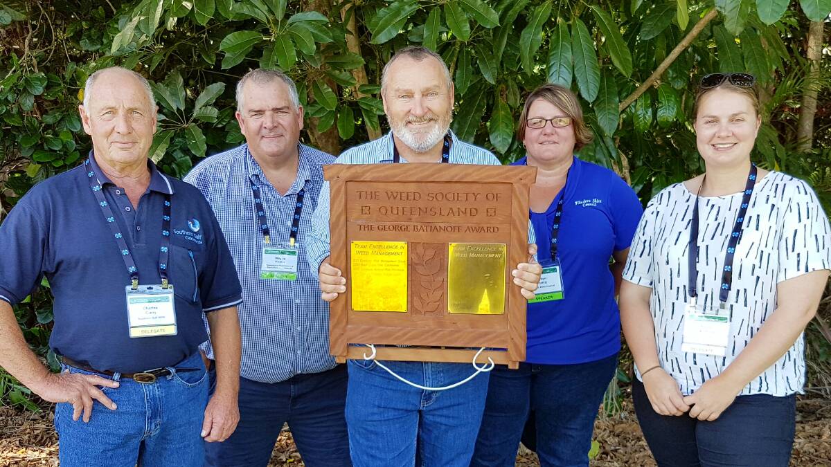 WoWW prickly acacia project team representatives accepting the  George Batianoff Team Excellence Award at the Queensland Weeds Symposium in Port Douglas - Charles Curry, Southern Gulf NRM, Dr Wayne Vogler, Tropical Weeds Research Centre, project leader Nathan March, DAF Cloncurry, Robyn Young, Flinders Shire Council, and Kelsey Hocking, Tropical Weeds Research Centre.