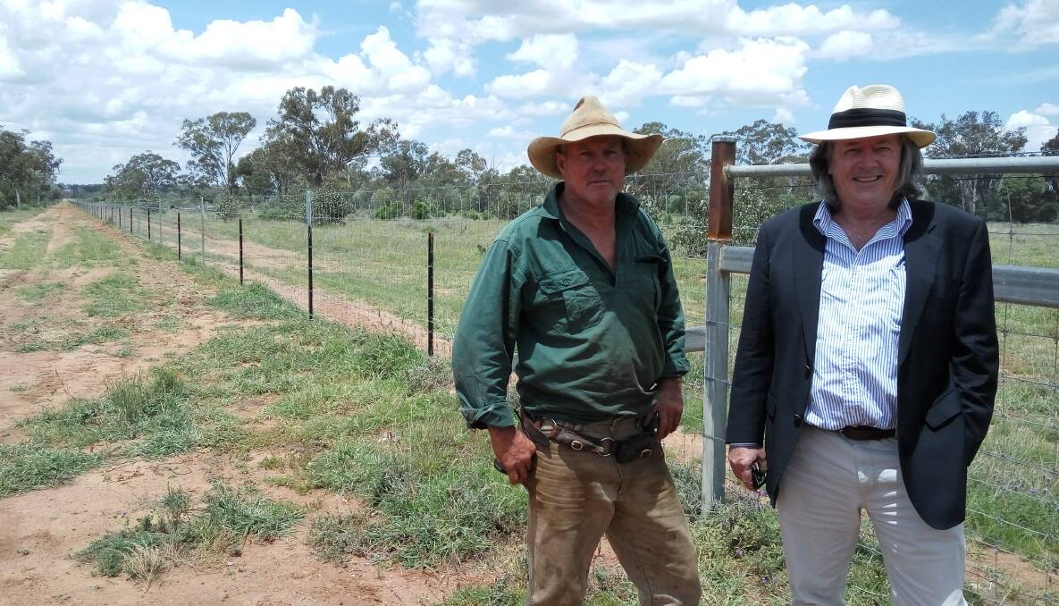 Morven landholder Scott Sargood, a member of the Wellwater cluster, inspecting an exclusion fence at Bundoo with South West NRM chairman, Mark O’Brien.