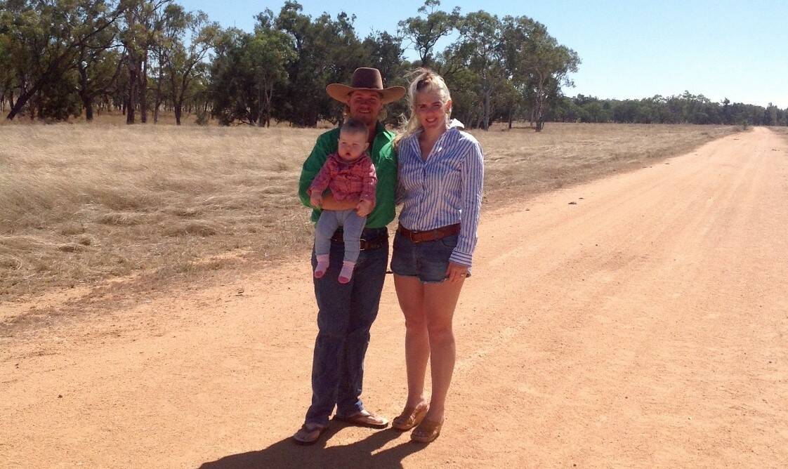 Logan and Katie Casey, with their daughter Paizley, at the site of the wild dog attack.