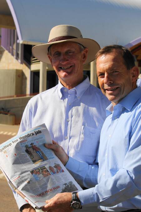 Federal MP Bruce Scott and then opposition leader Tony Abbott, pictured reading the Bible of the Bush, the Queensland Country Life, at the Australian Stockman's Hall of Fame in 2013, when the $5m funding pledge was made.