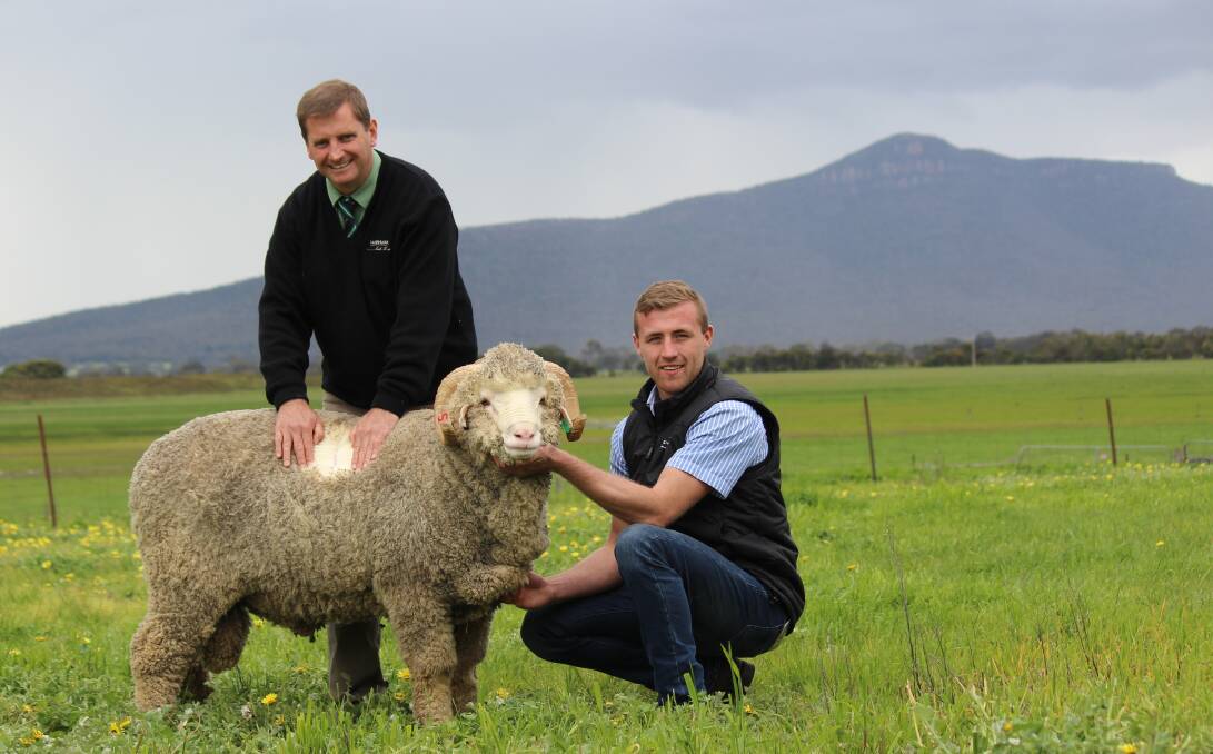 Top price: Landmark southern NSW stud stock representative Rick Power with Rock-Bank's Sam Crawford and the $10,500 top priced ram. 