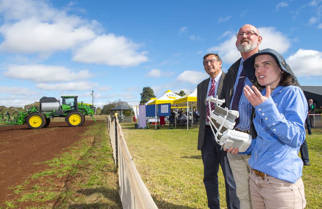 Kerry Shine, Minister for Agriculture and Fisheries and Minister for Rural Economic Development William Byrne and USQ researcher Dr Cheryl McCarthy look at the drone technology currently being used for research at USQ. Photo: USQ Photography 
 