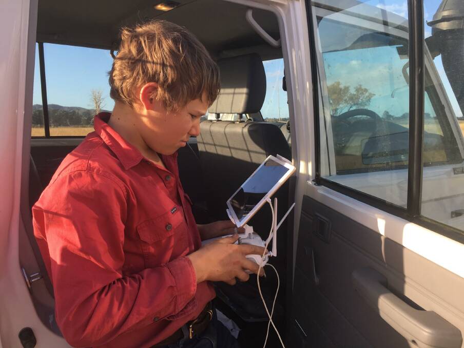 Andrew McArthur, 13, uses the drone blocking cattle from the cab of the ute.