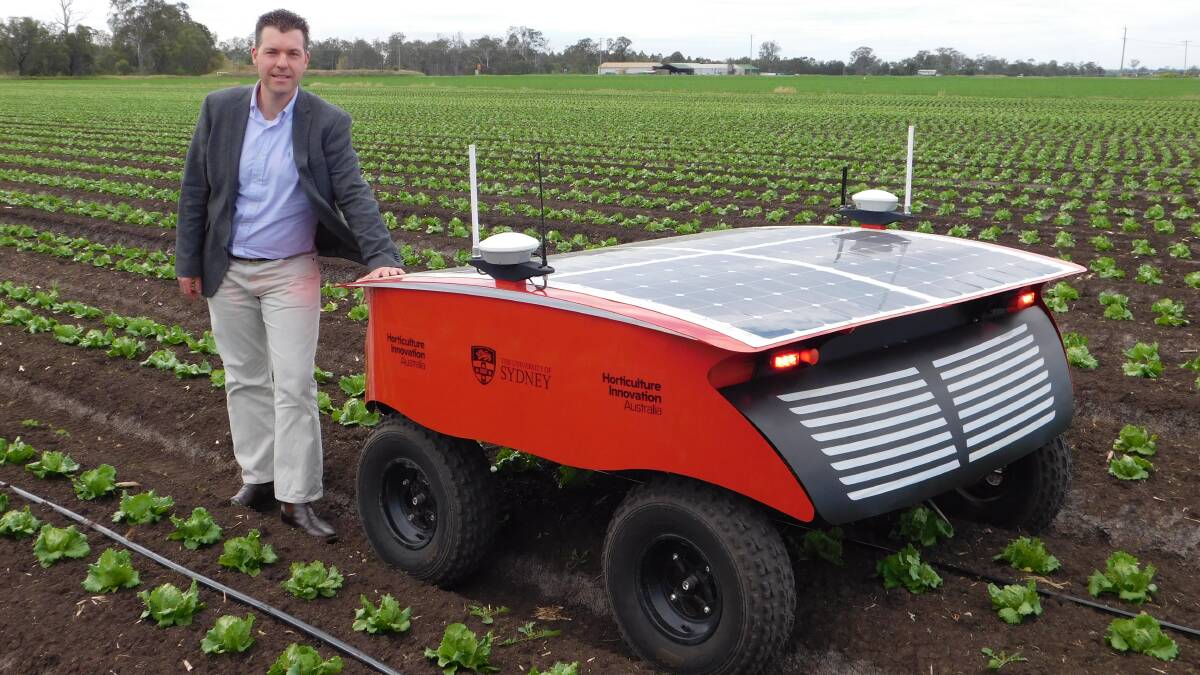 FIELD TEST: HIA research and development lead Dr Anthony Kachenko with RIPPA, a prototype robot which can detect weeds and foreign bodies within a paddock.