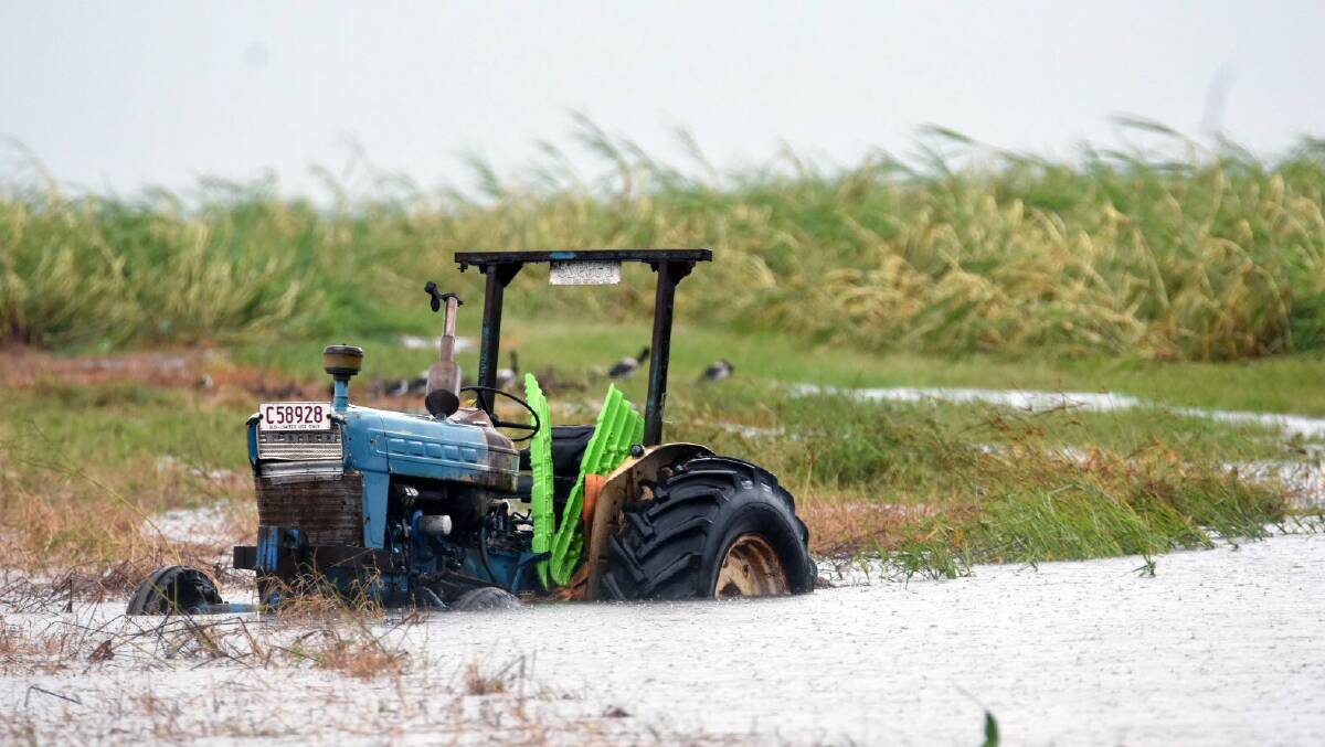 A tractor is inundated with water on a property south of Bowen. 