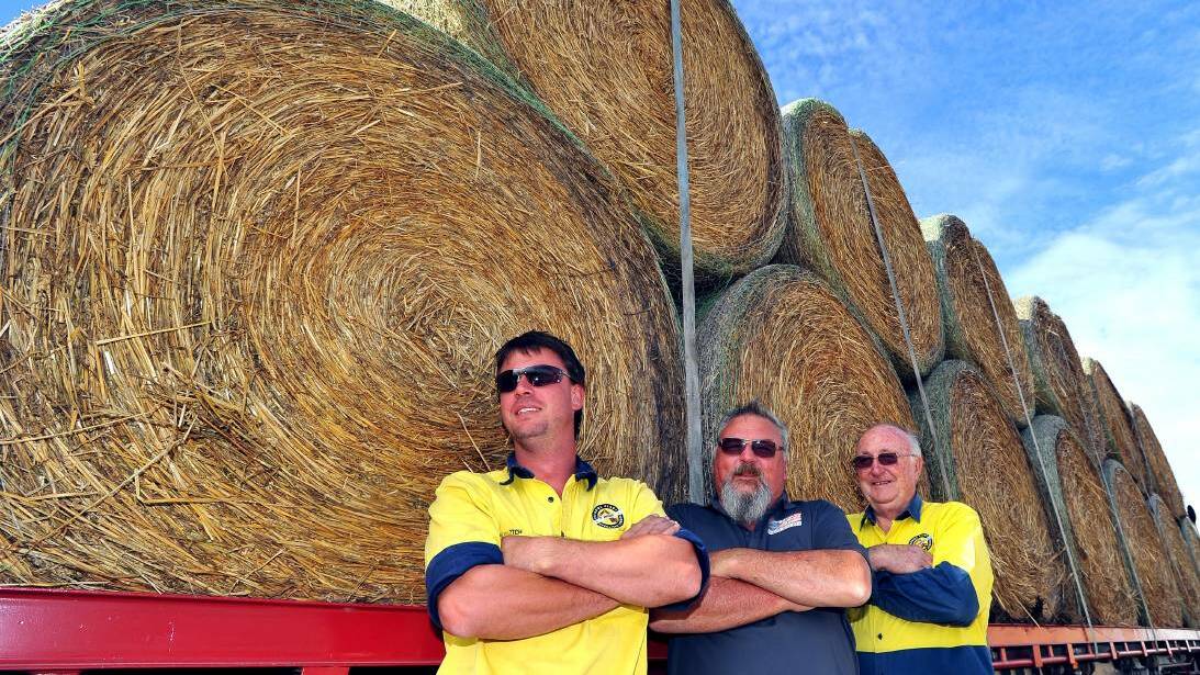 Big trip: Mitch Quade, Stephen Smith and Keith Montgomery of Riverina Plant Operators School prepare to leave Wagga to join the Burrumbuttock Hay Runners to deliver hay to Ilfracombe. Photo: Kieren L. Tilly