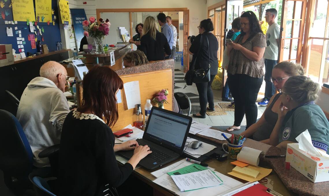 The busy registration desk at Helping Hands, Lismore.