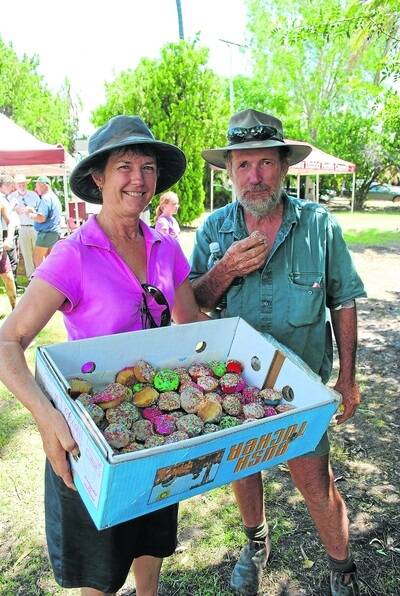 LEFT: Trevor Brownlie shows he is still in good spirits at a Cotton Australia barbecue last Thursday, kindly accepting a cupcake from Diane French, Nandina, Theodore.