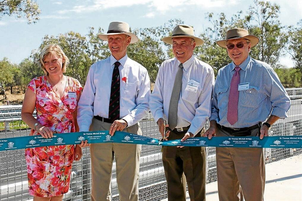 Deputy Prime Minister and Minister for Infrastructure and Regional Development Warren Truss cuts the ribbon to officially commission the Sir Thomas Mitchell Bridge with (from left) Department of Transport and Main Roads deputy regional director for Downs South West Kym Murphy, Federal Member for Maranoa Bruce Scott and State Member for Warrego Howard Hobbs.