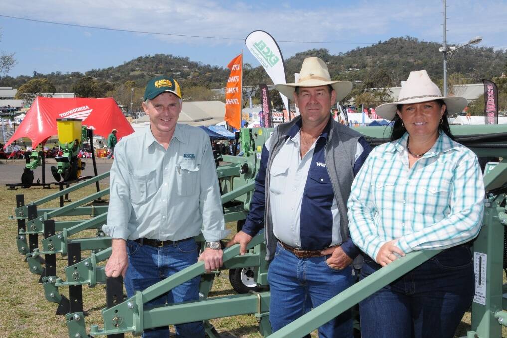 Excel Agriculture sales manager Brian Moran, Toowoomba, with first time Heritage Bank Ag Show visitors, Dan and Shelly Brown, Calen, discussing the 12m Excel Cultivator which has a unique fold and comes with both cat 3 and cat 4 linkage and can be used for inter-rowing cotton, corn and sorghum. - Picture: SARAH COULTON.