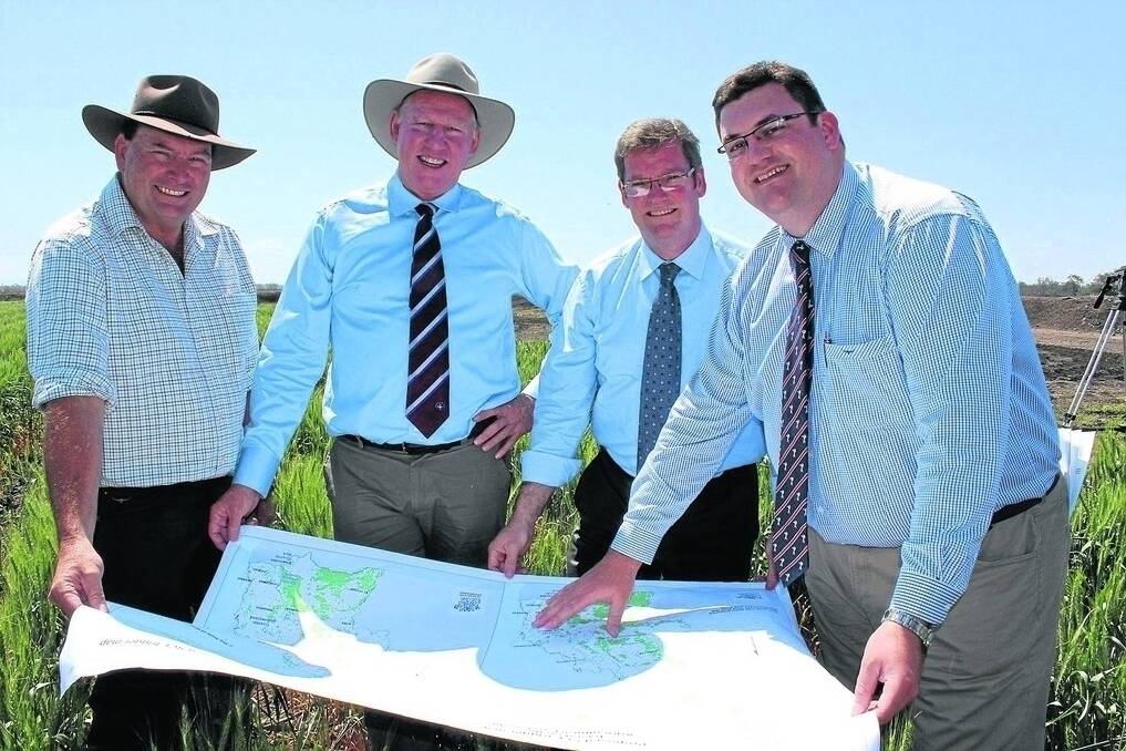 Kim Bremner, The Meadows, Dalby, looks over maps detailing the SCL increase with Deputy Premier Jeff Seeney, Agriculture Minister John McVeigh and Natural Resources Minister Andrew Cripps. - Picture: KATE STARK.