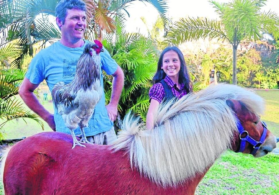 Mel Gibson the rooster with owner Matthew Smith and Matthew's daughter Trinity Smith.