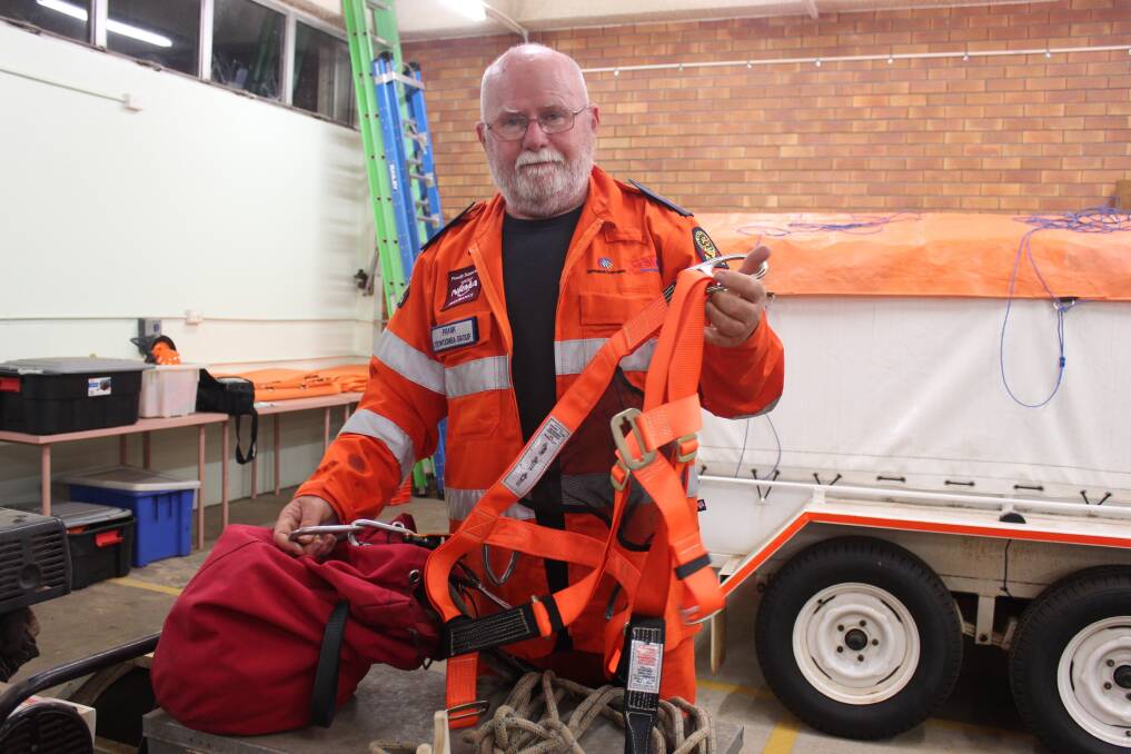 Toowoomba SES group leader Frank Devlin inspecting a height safety kit.