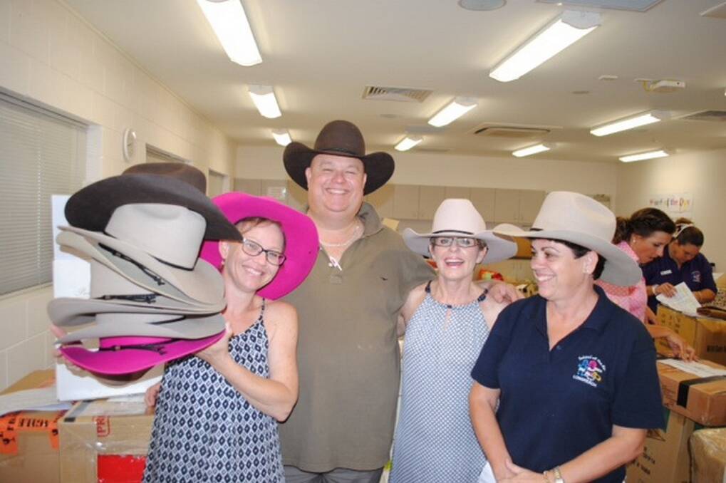 Longreach School of Distance Education parents with some of the 150 Akubra hats given out to LSDE families.