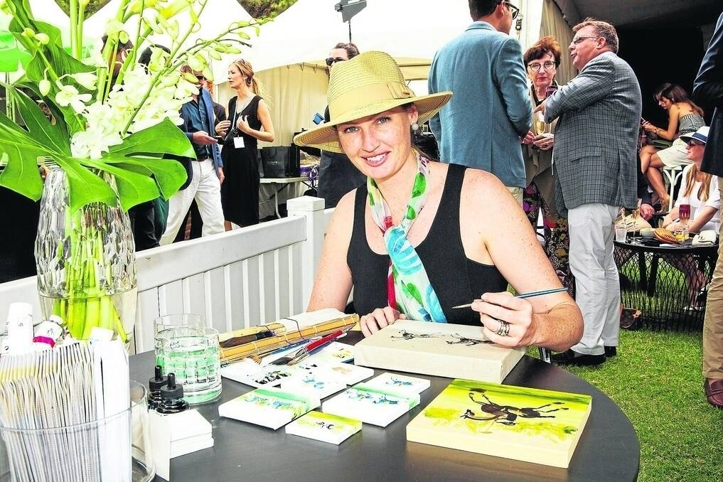 Mungallala artist, Laura Douglas, hard at work during a recent Polo in the City game.