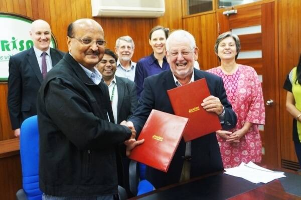 ICRISAT deputy director general for research Dr CLL Gowda exchanging the signed MoU with HIA director David Cliffe at the ICRISAT global headquarters in Hyderabad, India.