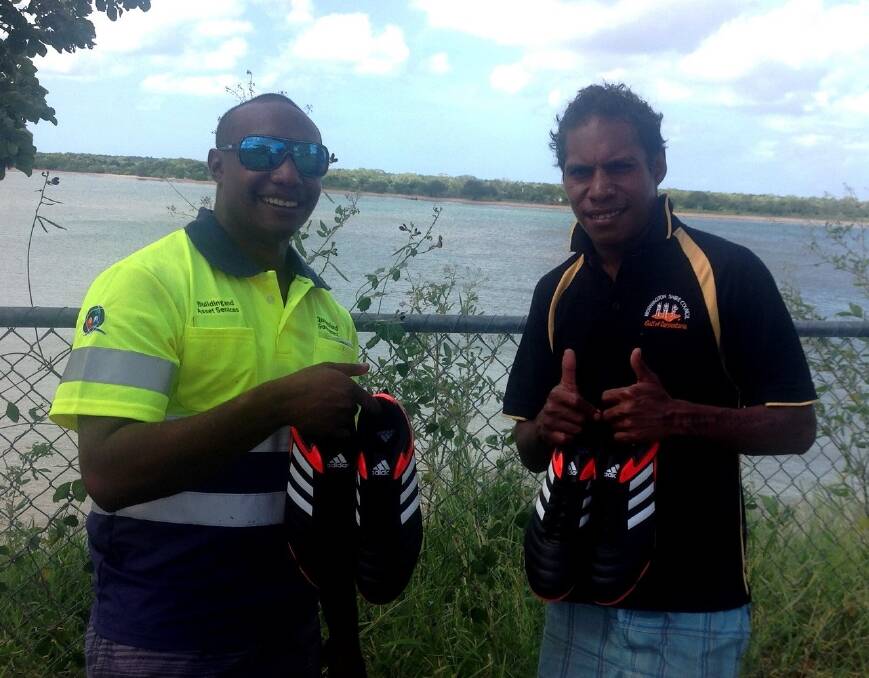 Mornington Island Raiders players Dale and John Amini show off two pairs of footy boots sent all the way from Adelaide. following a call to shoe the remote rugby league team. Once all the donated boots arrive on the weekly barge, a gala training event will be organised to hand them out to all the children and budding sports superstars.