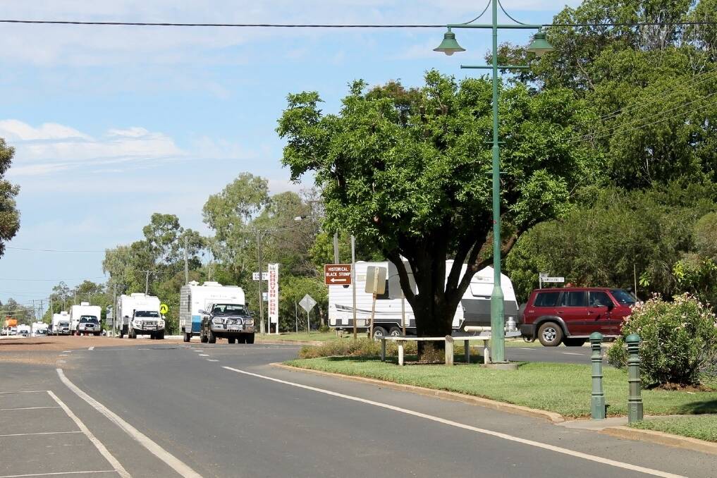 Caravan convoys such as this one rolling into Blackall, are being welcomed as rural economies face severe declines and staff cuts.