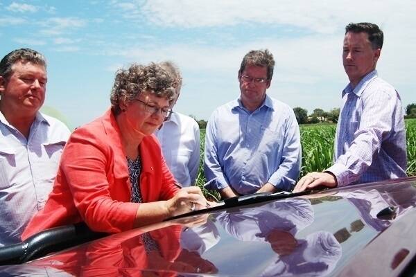 Queensland AgForce vice president Georgie Somerset signing the Memorandum of Understanding at the launch of the now defunct Agricultural Energy Council in Bundaberg last December. 