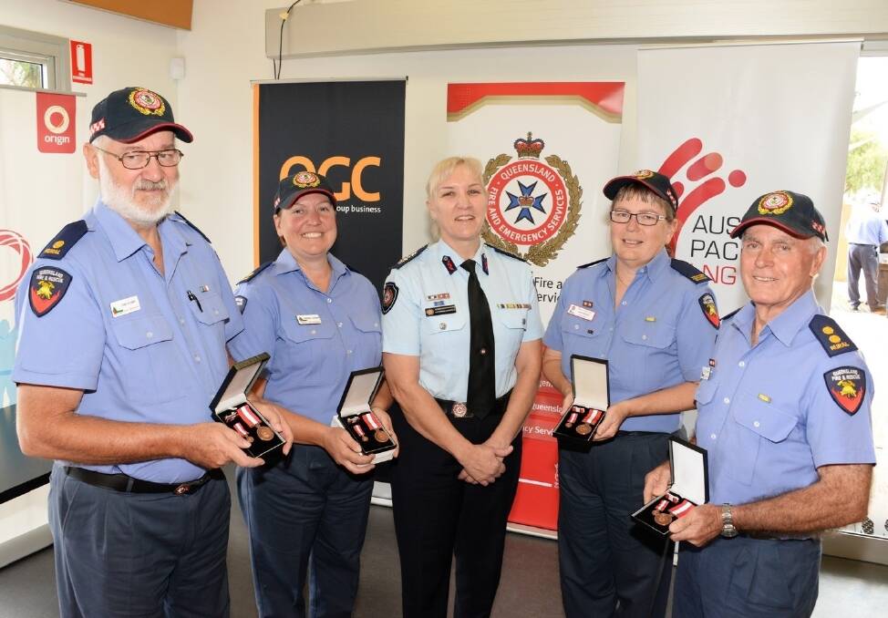 Kogan and District Fire Brigade firefighters John Hughes, Rachael Jacobsen, Vicki Searle and Paul Storey, accepting Diligent and Ethical Services medals from Queensland Fire and Emergency Services acting commissioner Katarina Carroll, Brisbane. <i> - Picture: SARAH COULTON.</i>