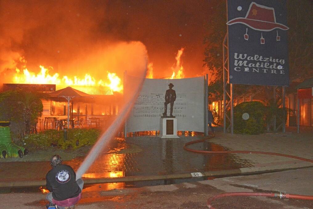 Locals work to put out the blazing fire at the Waltzing Matilda Centre. <i>- Picture: JOHN ELLIOTT.</i>