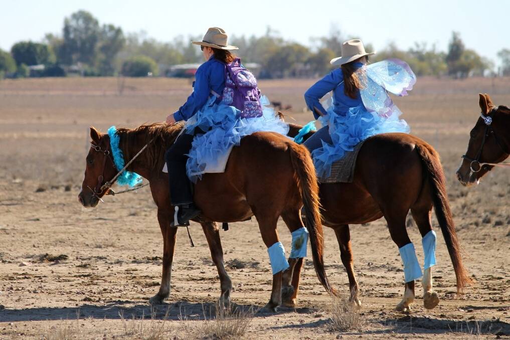 Two of the La Nina Fairies from Springsure eyeing the finishing line at Longreach after a long 27 kilometre ride.