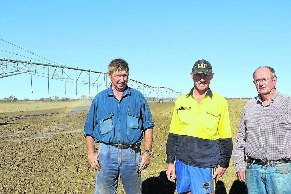 Longreach Pastoral College farm manager Rob Carr, production manager David Carr and agribusiness program manager Charlie Nolan admiring the new centre pivot irrigation system ready to water a 15ha oats crop on their Longreach farm.