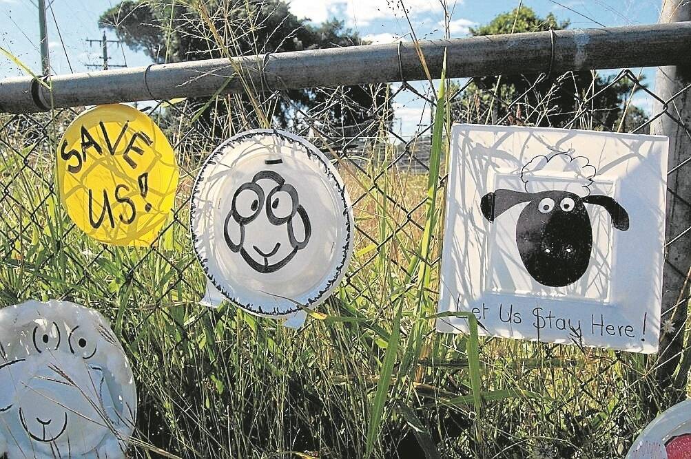 Some of the “plate protest” signs which have been put on the fence of the Childers land.