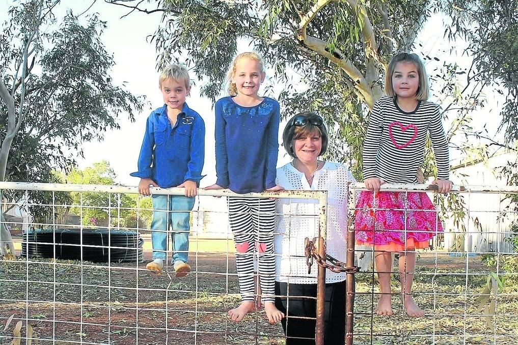Katherine and children Zander, 4, Chloe, 7 and Tilly, aged 6. They are enrolled with the Alice Springs School of the Air, 550km to the south.