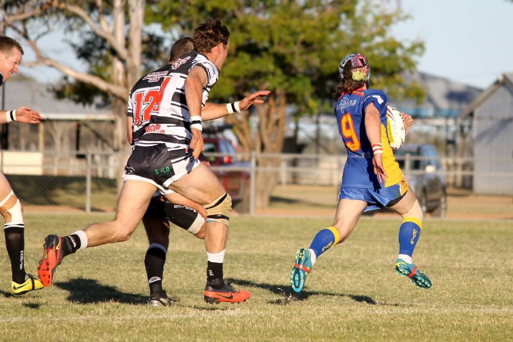 Winton's Justin Smith shows a clean pair of heels to the Blackall defenders in the central west curtain raiser to the Intrust Super Cup game held in Blackall as part of Country Week.