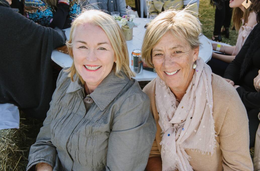 Leesa Deacon and Di Lyne enjoying the day out in the sun, taking a second to sit down to relax.