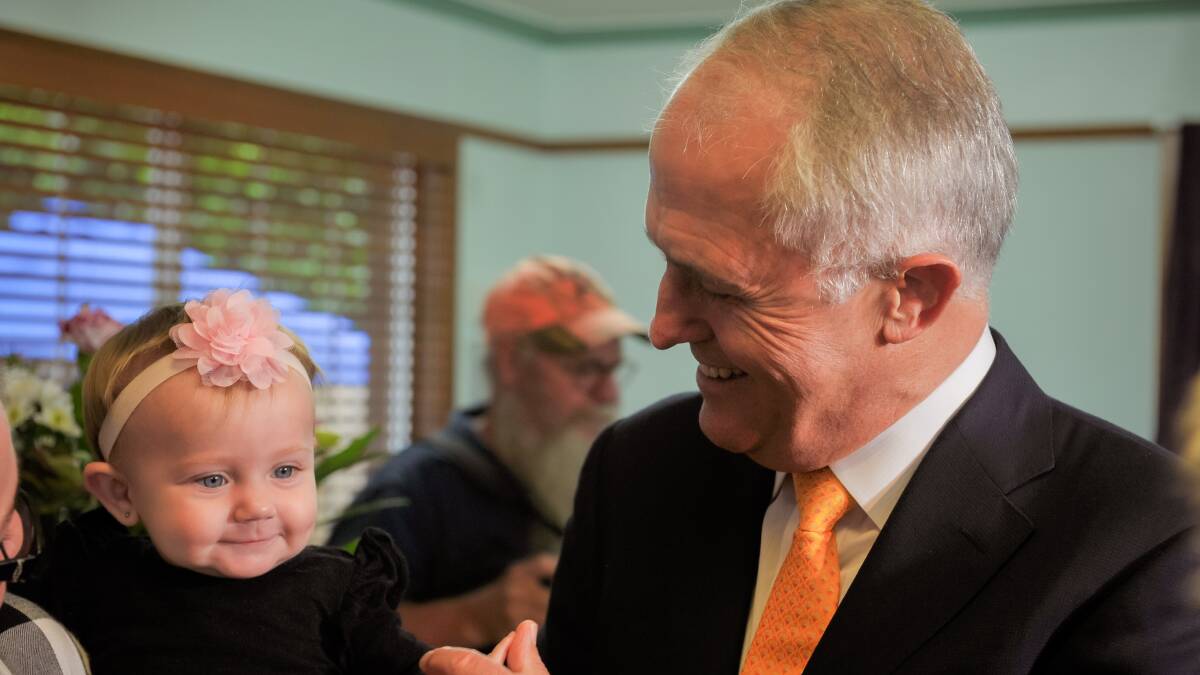 Prime Minister Malcolm Turnbull meets Lylah Robinson, who's mum Chantelle Colbourne is part of the Rockhampton program. Photo - Kelly Butterworth.