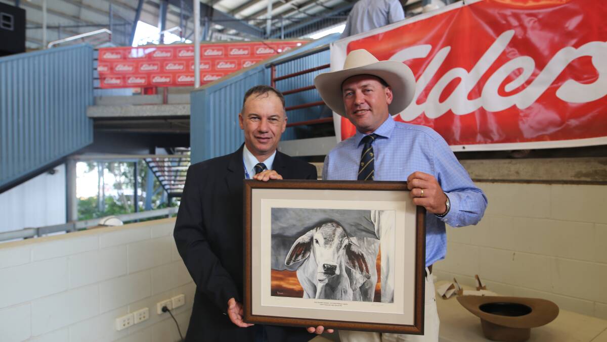 ABBA president shane Bishop, Garglen, Gympie, presents Mark Wilson, Banana Station, Banana on being the most successful exhibitor at the Elders commercial cattle show and sale. 