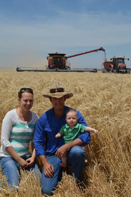 Bright days: Margie and Andrew Milla and their son Cooper, Austin Downs, Surat, were hoping clear skies would hold on until their wheat harvest wrapped up.
