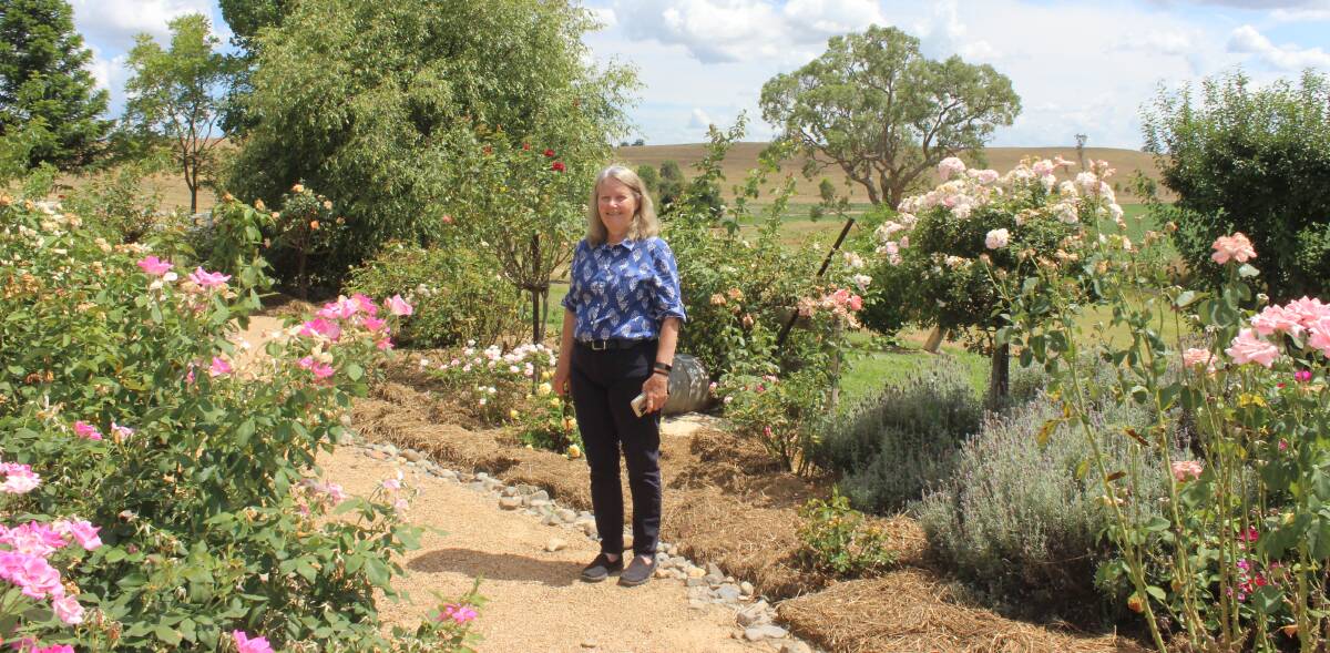 Colleen Lindores in the memorial rose garden that she created to remember family and friends. 