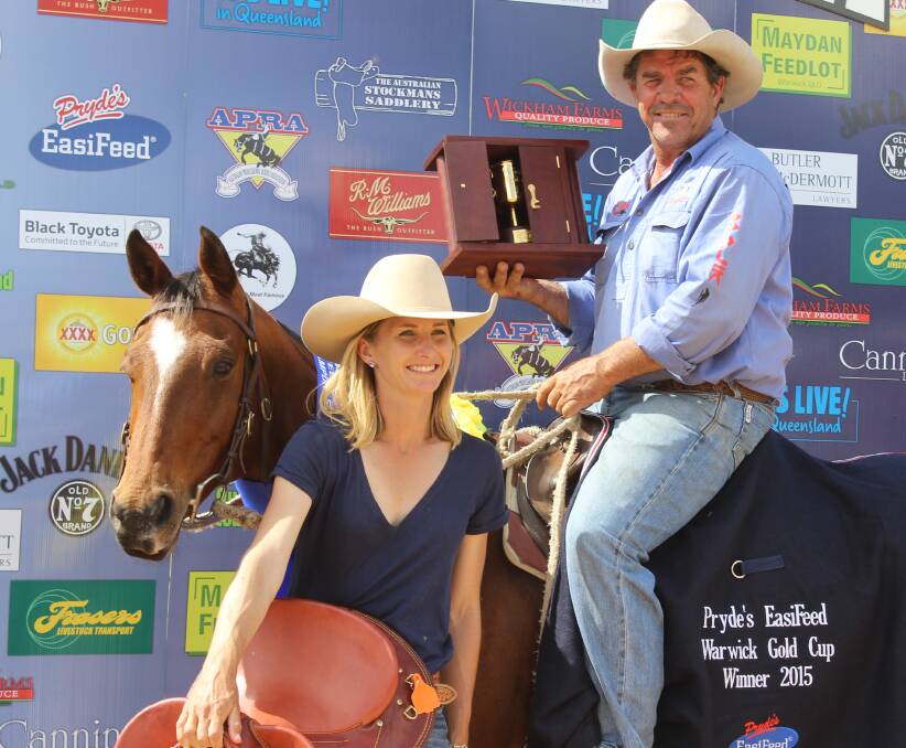 Ben Tapp astride Acres of Roses with the Warwick Gold Cup in hand, while his partner Kylie Barnett holds his winning saddle. 