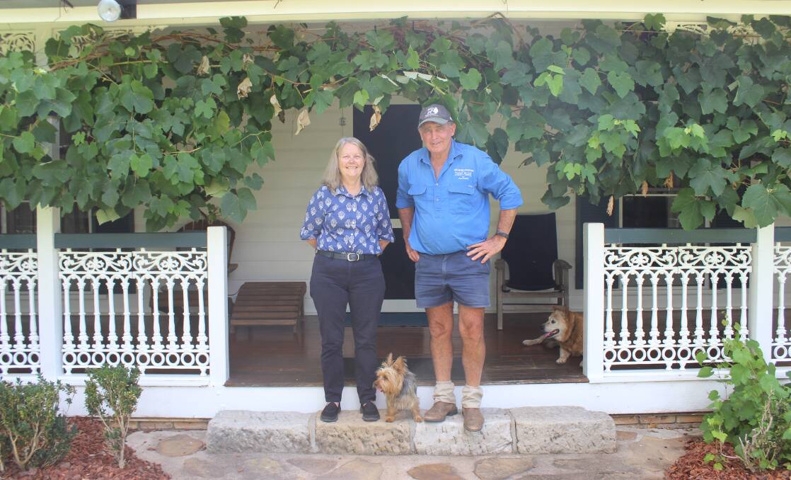 Colleen and Peter Lindores with family pet Tilly on the front steps on Melrose Station homestead. 